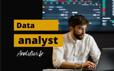 Un homme concentré sur son ordinateur portable, prêt à devenir data analyst. Graphiques financiers en arrière-plan.