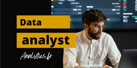 Un homme concentré sur son ordinateur portable, prêt à devenir data analyst. Graphiques financiers en arrière-plan.