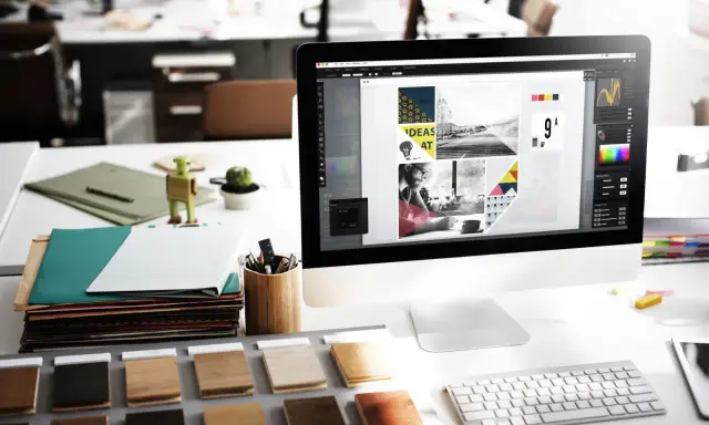 Bureau de graphisme avec écran affichant des idées créatives. Le marketing digital est un domaine prometteur, avec un bon salaire potentiel.
